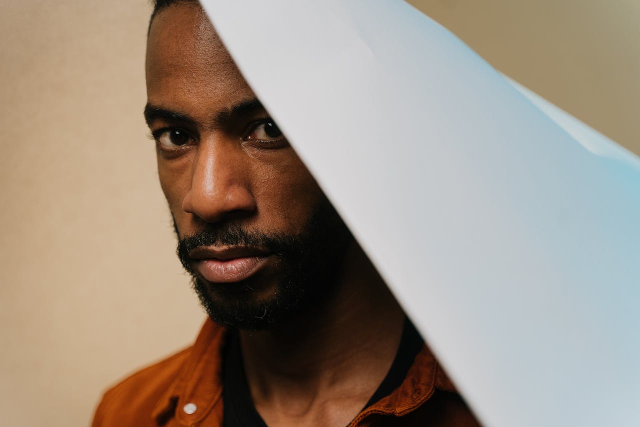 Mastering the First Impression: Your intriguing post title goes here Artistic close-up portrait of a man with a beard, looking directly at the camera with creative lighting and composition.